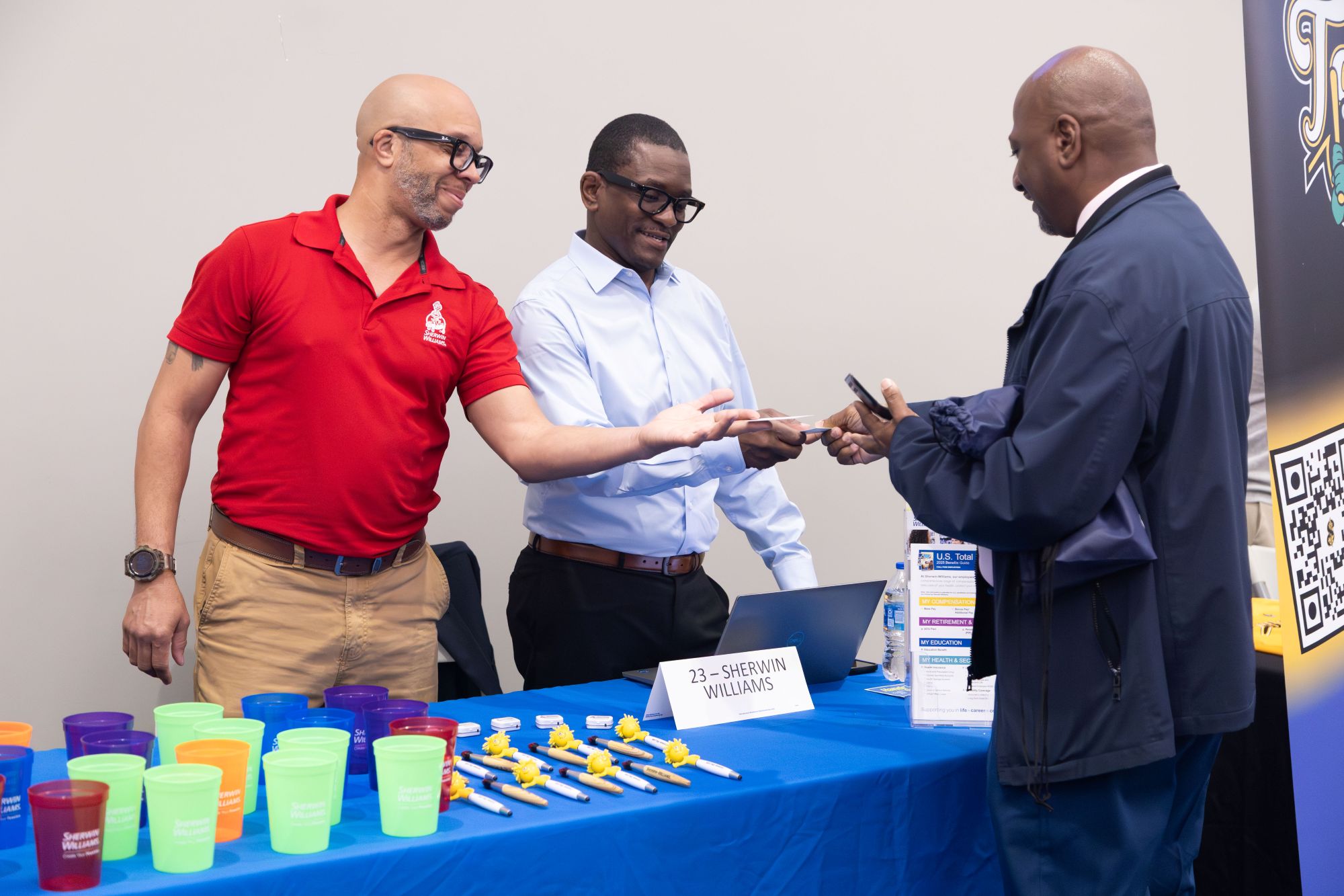 employees hand a man business cards