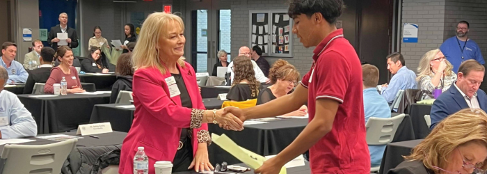 Student from Joco works program shaking hands 