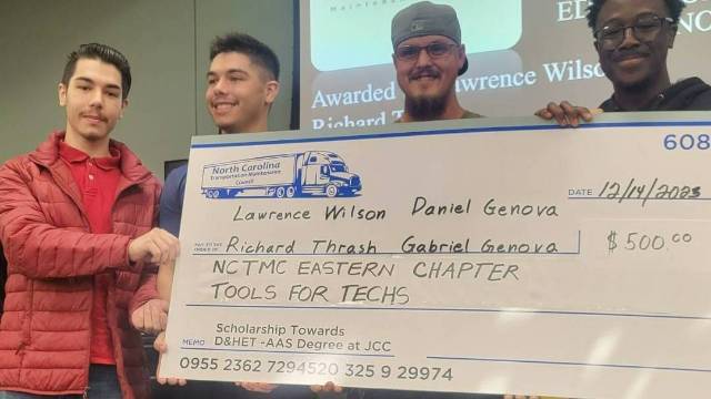 JCC students receiving a check for $500