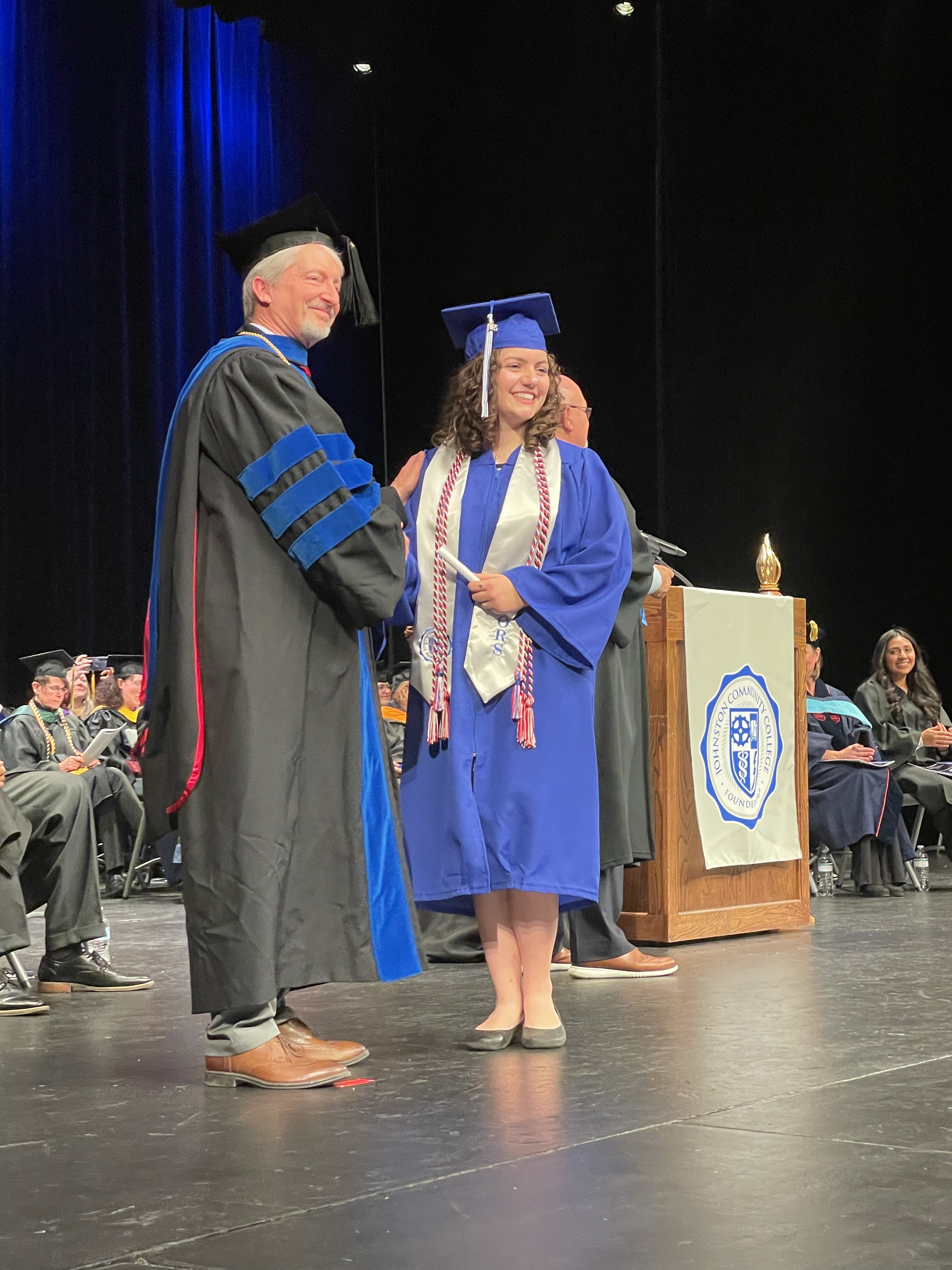 Graduate taking diploma from President on stage