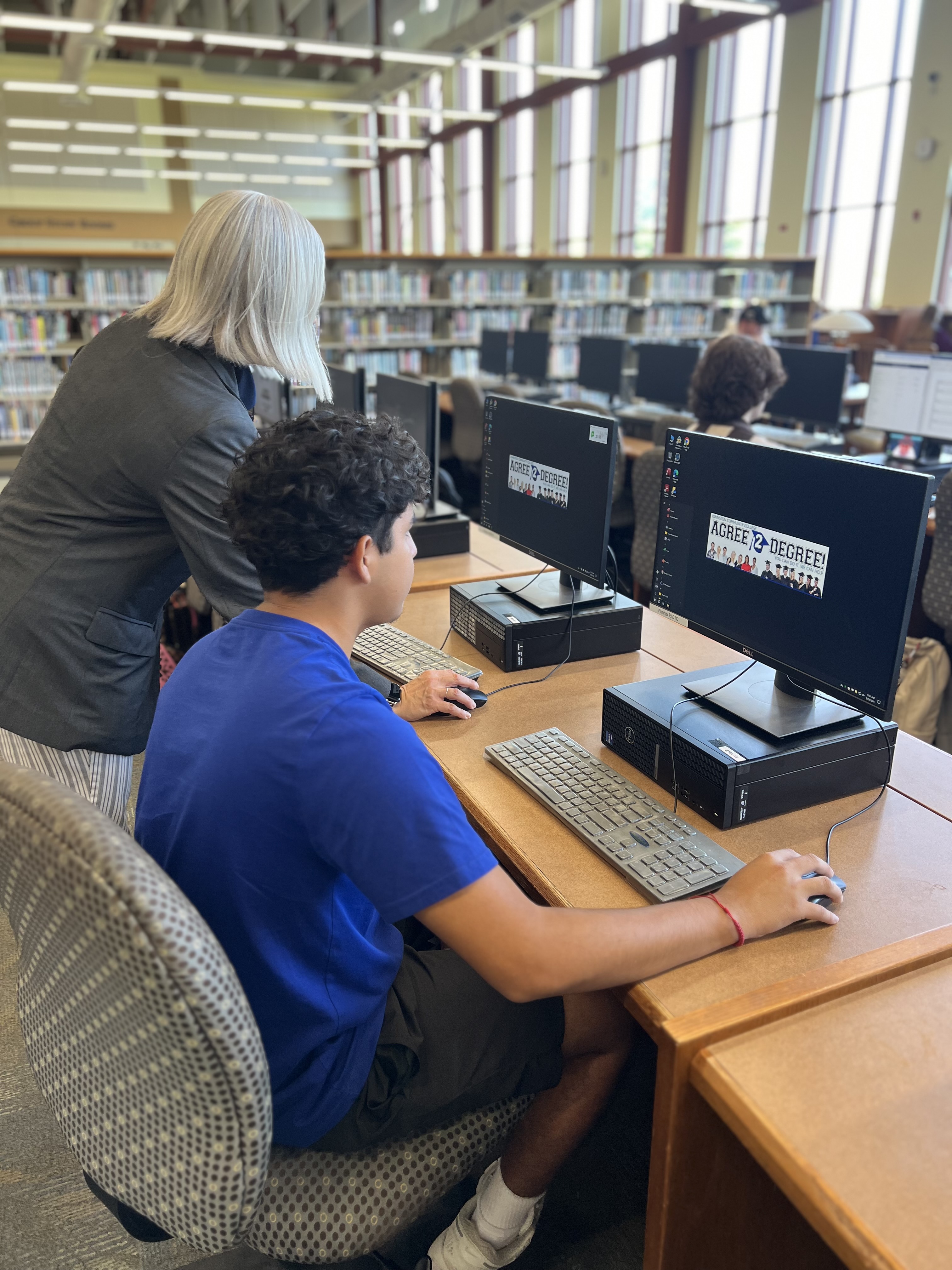 Student getting help at library with computer