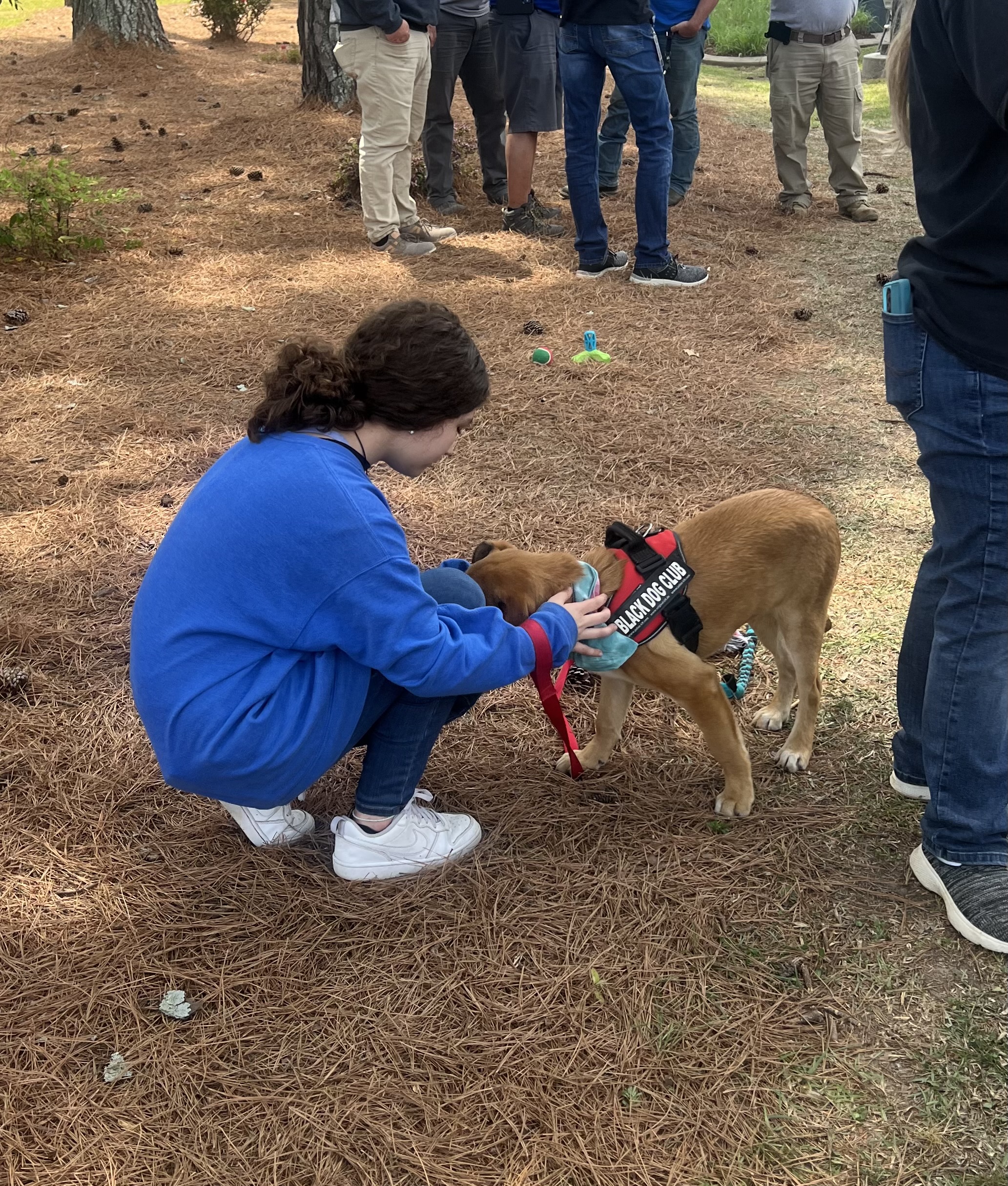 student petting support dog