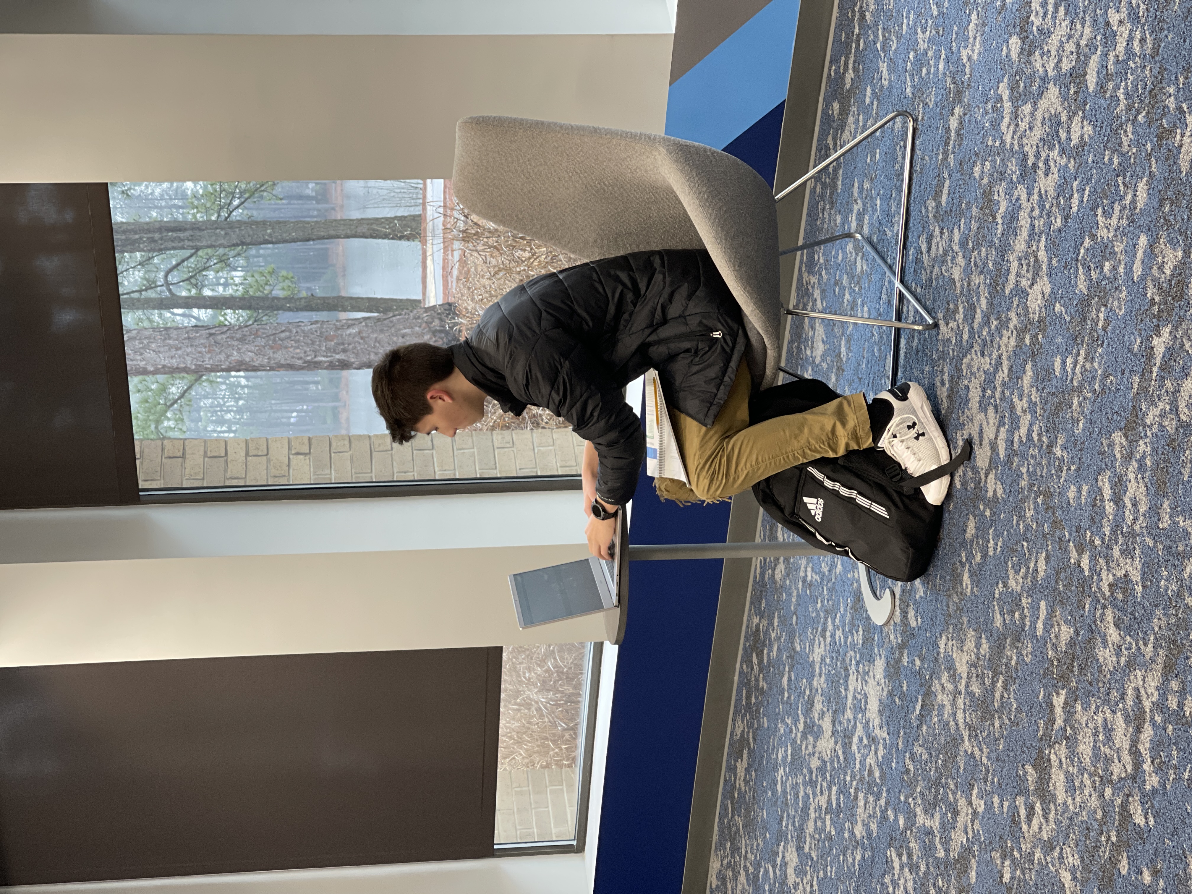 Student sitting at table with laptop in Student Success Center