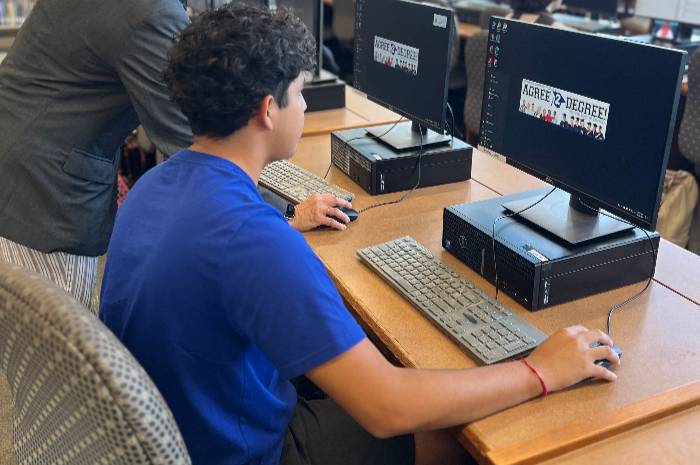 Student getting help at library with computer