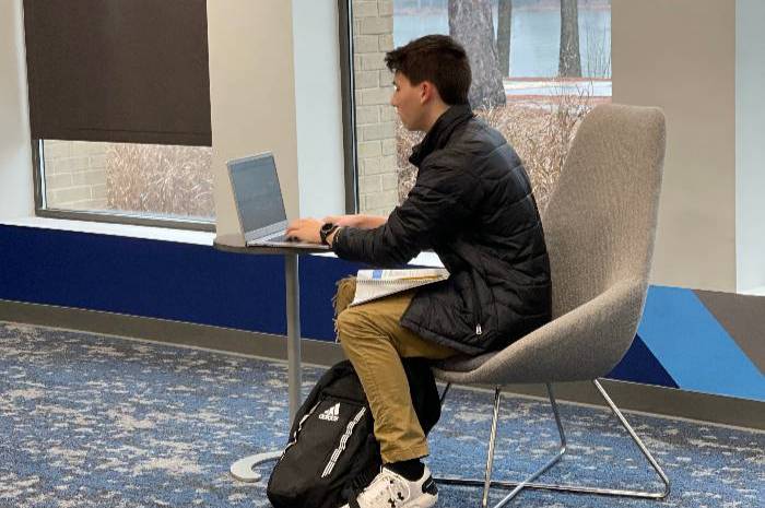 Student sitting at table with laptop in Student Success Center